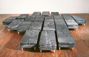 Guillermo Kuitca, Untitled, 1992, acrylic on mattress with wood and bronze legs, 20 beds: each 15 ¾” x 23 5/8” x 47 ¼”. Courtesy Miami Art Museum